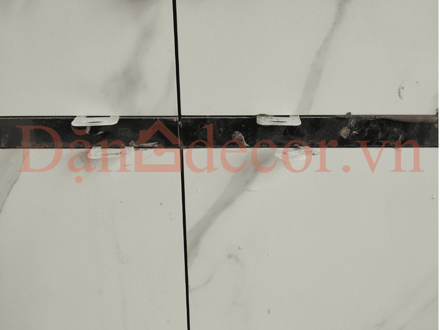 Chi tiết ke cân bằng nhựa trắng được Đặng Decor sử dụng giúp mảng tường ốp gạch phẳng tuyệt đối khi thi công xây nhà tại Vũng Tàu.